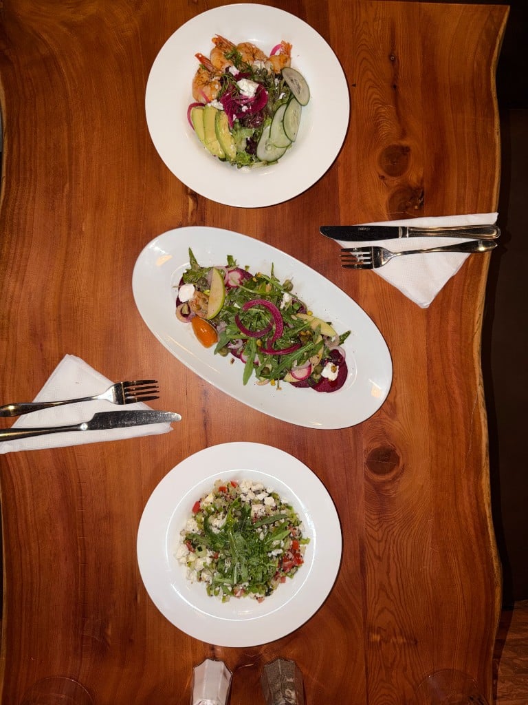 Trois salades sur la table en bois massif, vues de dessus
